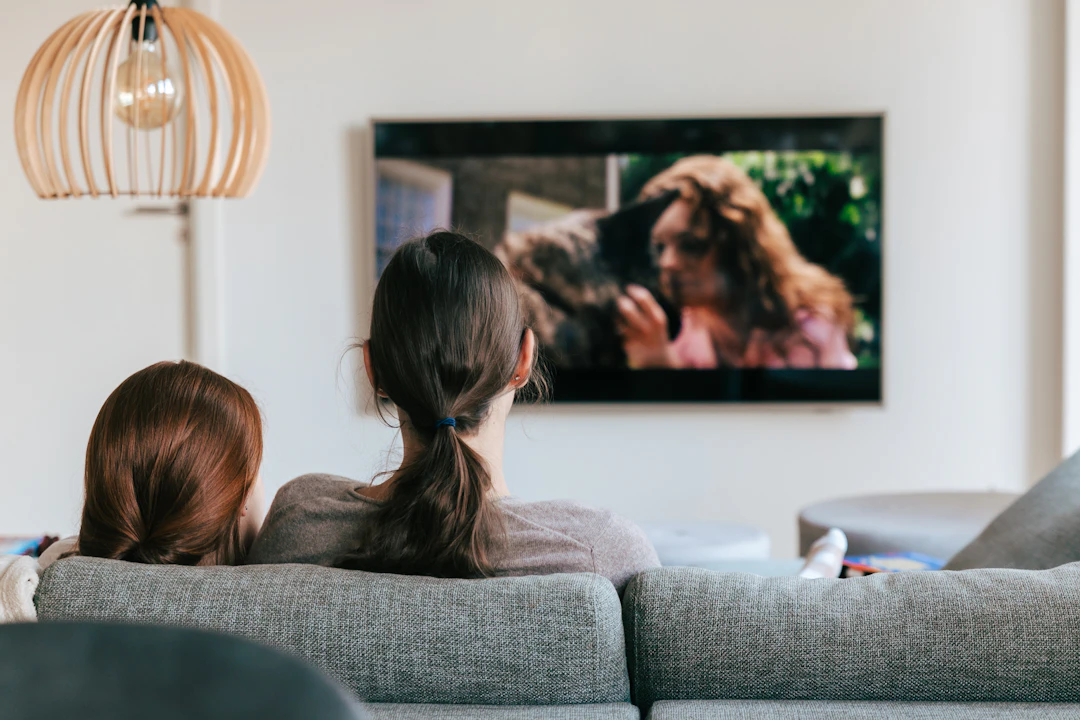 Family watching television together at home